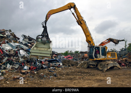 Déchargement de la voiture sur une pile dans un parc à ferraille métallique. Banque D'Images