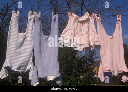 Vêtements de bébé accroché sur la ligne - bleu pour les garçons et rose pour les filles Banque D'Images