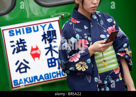 Young Girl wearing yukata kimono en été, dans le quartier de Shibuya à Tokyo, Japon. Banque D'Images