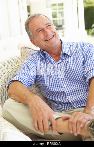 Portrait of Senior Man Relaxing in Chair Banque D'Images