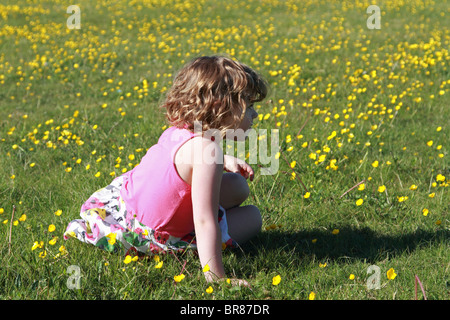 Girl sitting in field Banque D'Images