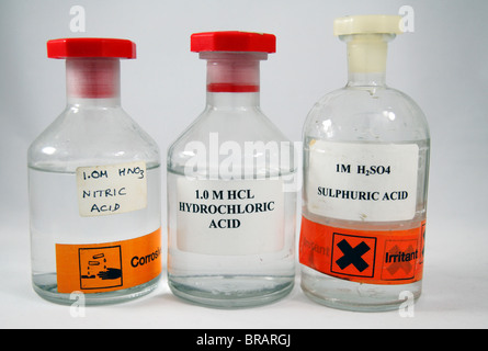 Trois bouteilles de 1 molaire (1.0M) acides de l'école tel qu'il est utilisé en Angleterre : l'acide nitrique, acide chlorhydrique et acide sulfurique. Banque D'Images