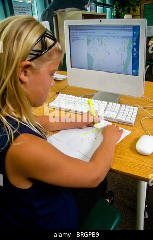 Une fille de l'école attire les grandes routes de quartier sur une carte téléchargée sur un ordinateur à San Clemente, CA. Banque D'Images