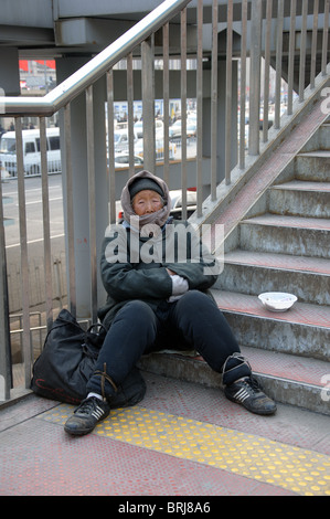 Une vieille femme mendiant chinois à la gare de Beijing, Chine Banque D'Images