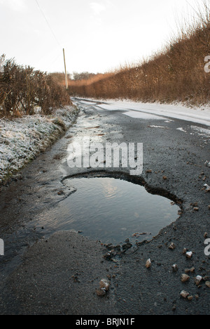 Poule dans une route de campagne causés par la neige et le temps de gel Banque D'Images