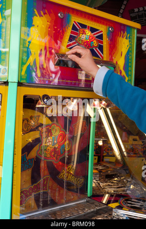 Mettre une pièce dans une machine à sous - Foire d'Abingdon dans l'Oxfordshire Banque D'Images