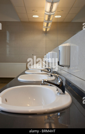 Rangées de lavabos et miroirs dans une toilette publique Banque D'Images