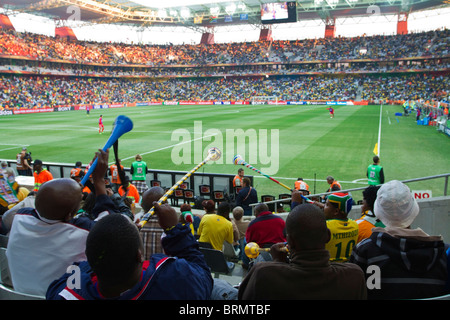 Vue arrière d'un soufflage des partisans de soccer pendant les vuvuzelas la coupe du monde 2010 Banque D'Images