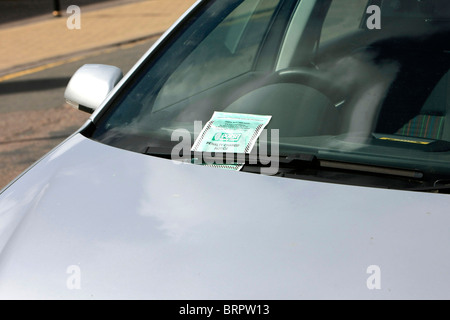 L'avis de pénalité plus connu comme un ticket de parking sur un pare-brise d'une voiture ayant été émis par un gardien de la circulation Banque D'Images