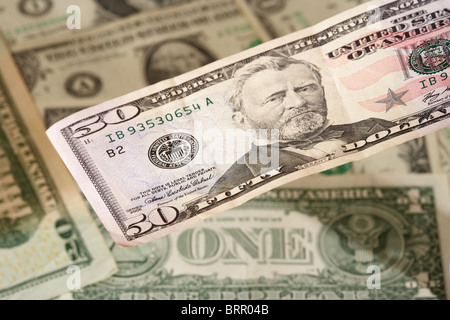 pile of us dollar banknotes with a fifty dollar bill Banque D'Images