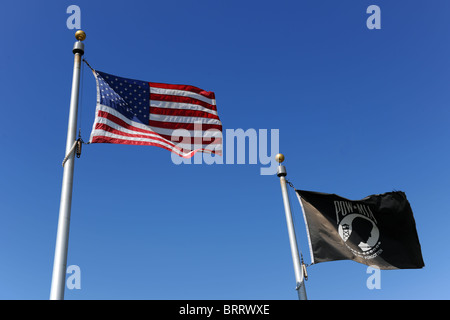 Aux États-Unis d'Amérique drapeau flotte à côté du drapeau noir POW/MIA plus de ciel bleu Banque D'Images