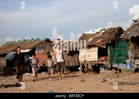 Une famille quitte un bidonville de squatteurs où les gens vivent dans la pauvreté sur la rive d'un fleuve du Mékong dans la région de Kampong Cham, au Cambodge. Banque D'Images