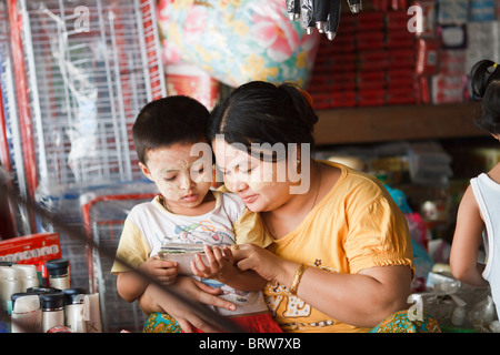 Une femme birmane aide son fils à lire, Mae Sot, Thaïlande Banque D'Images