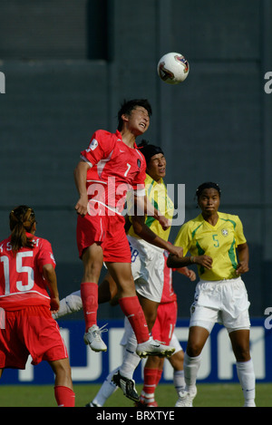 Eun Sun Park de la République de Corée (7) sauts élevés pour un en-tête sur Daniela du Brésil (18) au cours d'une Coupe du Monde féminine 2003 match Banque D'Images