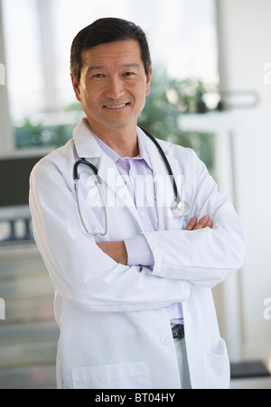 Smiling doctor with arms crossed Banque D'Images