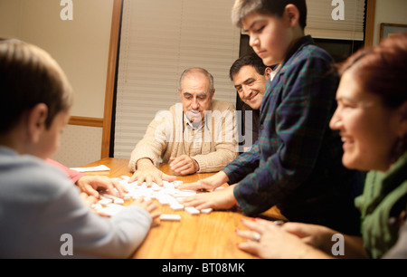 Multi-generation family playing dominoes at table Banque D'Images