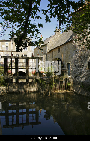 Ancien moulin à eau avec roue hydraulique le long de la rivière l'Aure à Bayeux, Normandie, France. Banque D'Images