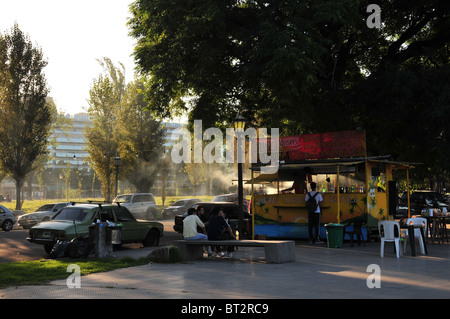 L'homme l'achat d'un fast-food grill parilla, nommé "Los Amigos", sous un grand arbre, Costanera Sur Boulevard, Buenos Aires Banque D'Images