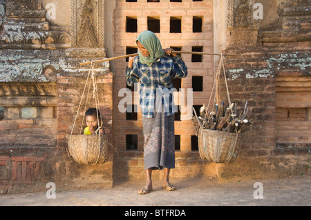 Femme birmane portant deux paniers, l'un avec son garçon, Bagan (Pagan), le Myanmar (Birmanie) Banque D'Images