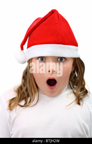 Surpris girl in Santa's red hat isolated on white Banque D'Images