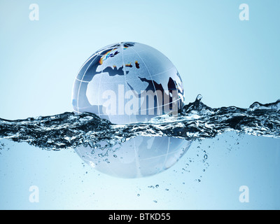 Un globe de verre flottant dans l'eau Banque D'Images