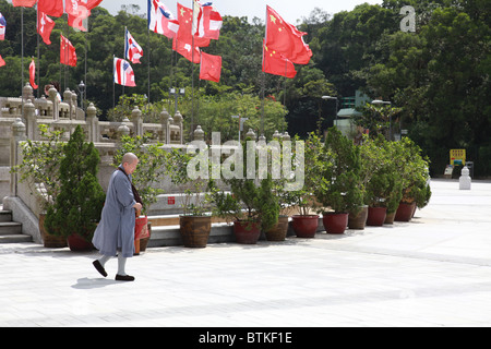 Monastère Po Lin avec un moine solitaire en passant devant tous les drapeaux chinois Banque D'Images