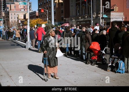 Une vieille femme passe devant l'ING New York City Marathon comme il passe par Harlem le Dimanche, Novembre 7, 2010 Banque D'Images