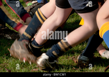 Les jeunes garçons à jouer au rugby dans une mêlée à l'extérieur en jeu à l'automne Banque D'Images