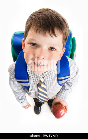 Vue de dessus de cute schoolboy avec sac à dos et apple looking at camera Banque D'Images