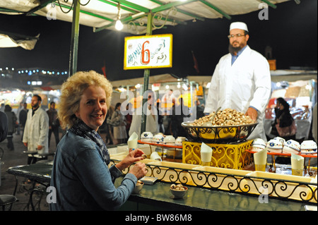 Woman Eating out au décrochage de l'escargot à la place Jemaa El Fna Marrakech Maroc Banque D'Images