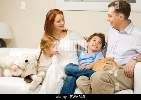 Les enfants curieux et la femme écoute attentivement à l'homme raconter une histoire intéressante Banque D'Images