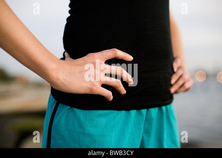 Runner with hands on hips in close up Banque D'Images