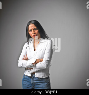 Young Hispanic woman femme vêtements casual, jeans, langage du corps, les bras croisés Banque D'Images