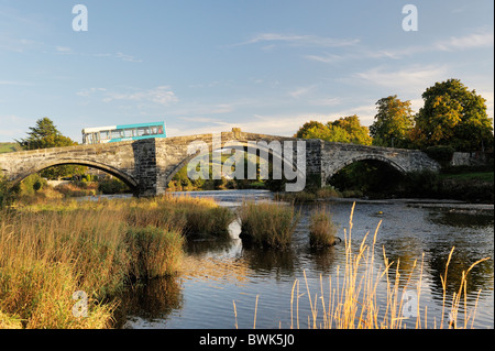 Bus arriva traverse la rivière Conwy sur le Pont Fawr bridge dans la vieille ville de Conwy dans la vallée de Conwy, Gwynedd, Pays de Galles, Royaume-Uni Banque D'Images