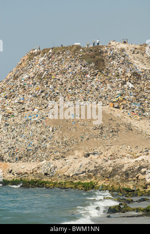 Les gens se tenant sur le haut de la montagne de déchets rejetés par le littoral méditerranéen à Saïda Liban Moyen Orient Banque D'Images