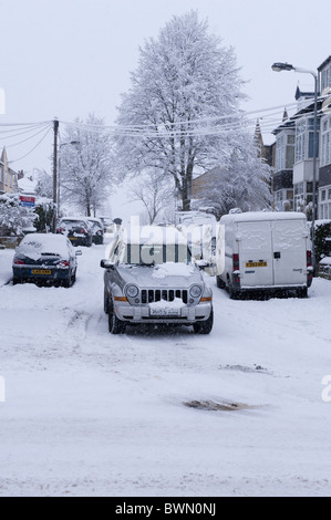 Une Jeep roulant le long d'une route enneigée. Banque D'Images