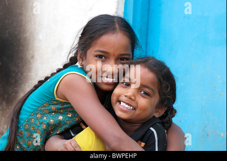 Village indien Smiling happy girls hugging. Les personnes âgées et les jeunes sœurs. L'Andhra Pradesh, Inde Banque D'Images