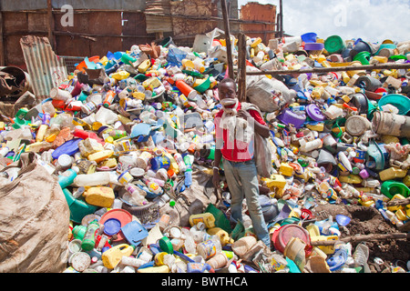 Jeu de garçon dans un centre de recyclage à Nairobi, Kenya Banque D'Images