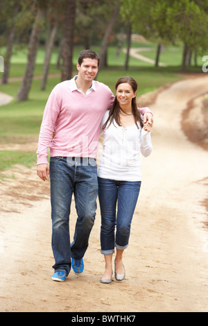 A senior woman posing on bicycle in park Banque D'Images