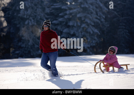 Femme fille enfant tirant sur le traîneau en bois en hiver paysage, Dobel, Forêt Noire, Gerrmany Banque D'Images