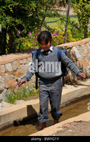 Une fille de l'école joue dans le conduit d'eau. Prince Albert, Afrique du Sud. Banque D'Images