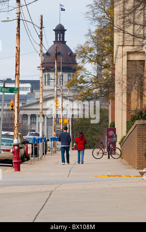 Deux personnes à pied le long de la rue principale vers la State House de Columbia, SC, en face d'un bâtiment des sciences du campus de l'USC. Banque D'Images