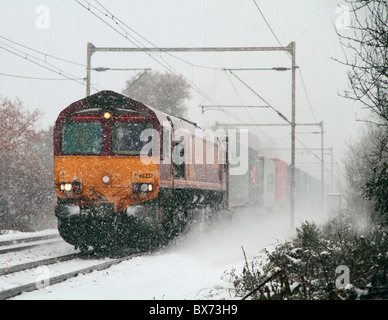 Un EWS/DBS 66 classe appartenant à un groupe de locomotives diesel de transport intermodal de marchandises près de Margaretting dans une tempête de neige. Banque D'Images
