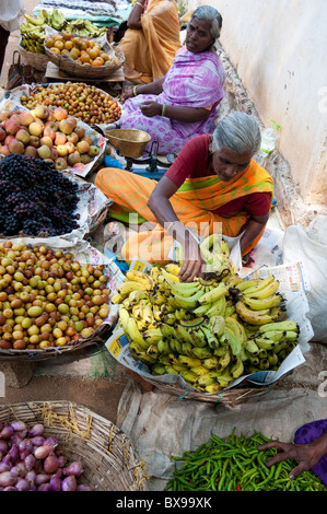 Les femmes indiennes à un marché de rue vendant des fruits et légumes. L'Andhra Pradesh, Inde Banque D'Images