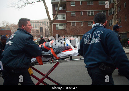 Les premiers intervenants déposer un cycliste dans une ambulance après avoir été frappé par un autobus à New York Banque D'Images