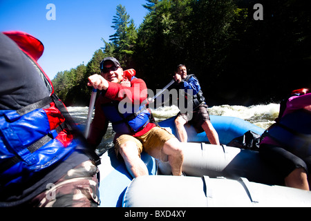 Un groupe d'adultes rafting dans le Maine. Banque D'Images