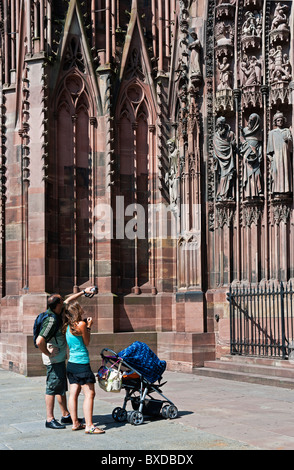 Jeune couple avec poussette de bébé à la cathédrale gothique Notre-Dame au 14e siècle, Strasbourg, Alsace, France, Europe Banque D'Images