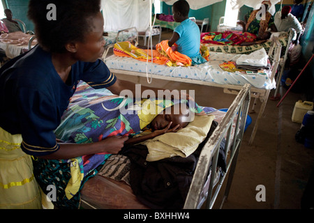 Une femme s'occupe de sa fille en train de mourir du sida en Amuria, Ouganda, Afrique de l'Est. Banque D'Images