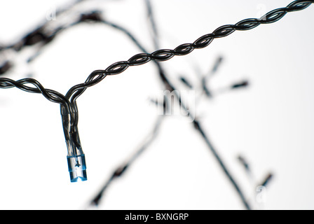 Arbre de Noël conte de lumière tourné sur un fond blanc avec la lumière à peu près visible, silhouette d'autres lumières visible Banque D'Images
