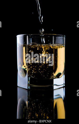 Verre de whisky sur un fond noir. Banque D'Images